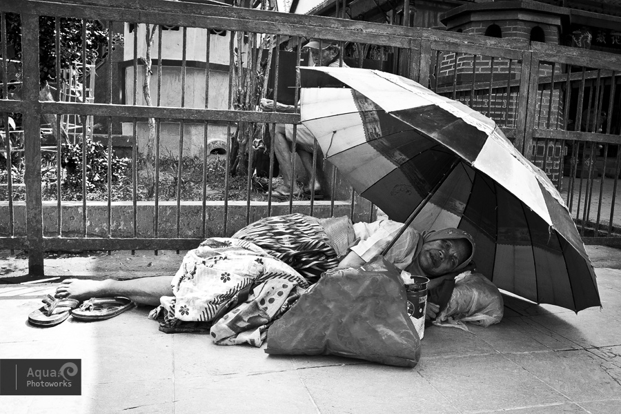 Beggar Camping Outside Temple